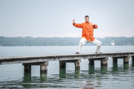 A man doing Qi-Gong in the early morning at the lake Starnbergの写真素材
