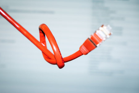 An image of a red networking cable with a knot