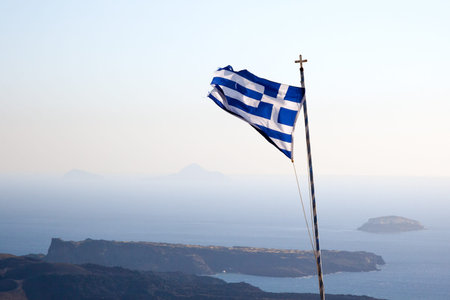 An image of the greek flag under a blue sky