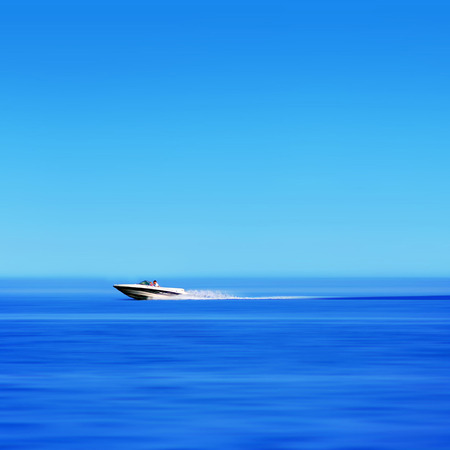An image of a fast speedboat on the big blue oceanの写真素材