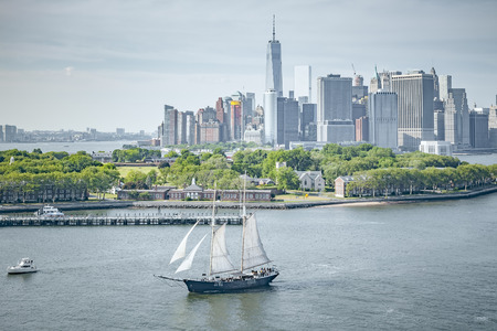 An image of a sailing ship in front of New York Manhattanの写真素材