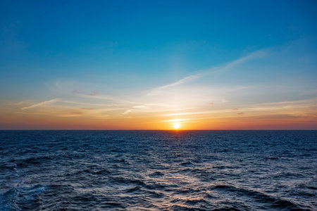 An image of a sunset over the atlantic oceanの写真素材