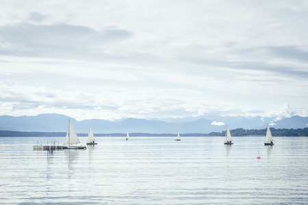 The Starnberg Lake in Bavaria Germany with sailing boatsの写真素材
