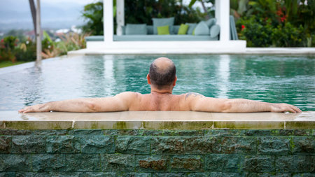 An image of a man relaxing in the pool