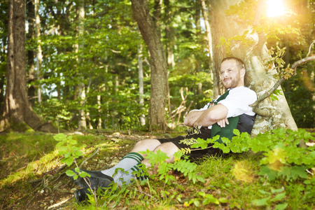 An image of a bavarian traditional man in the forestの写真素材