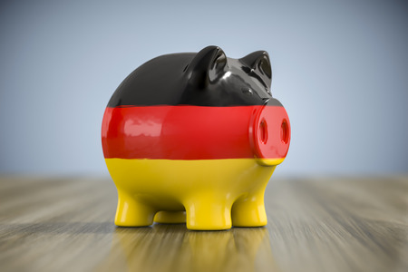 3d illustration of a fat piggy bank in german colorsの写真素材