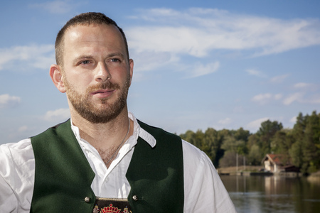 An image of a bavarian tradition man at the lakeの写真素材