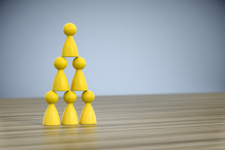 3d illustration of some game figures building a pyramidの写真素材