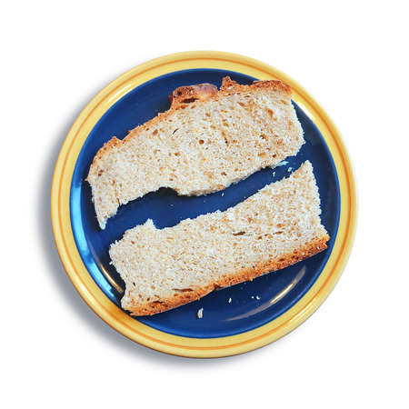 An image of a slice of bread broken in two piecesの写真素材