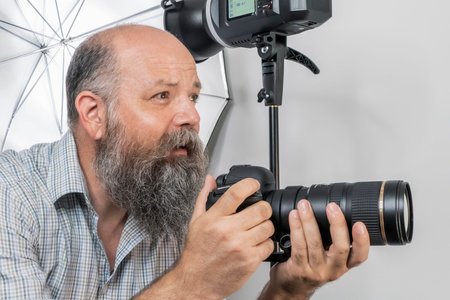 An image of a bearded senior photographer at work