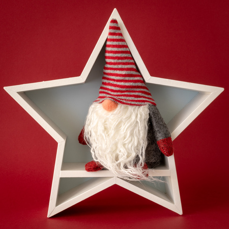 Christmas decoration white star with a gnome insideの写真素材