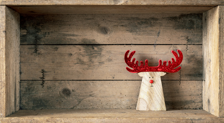 A wooden reindeer in a wooden box Christmas symbols decorationの写真素材