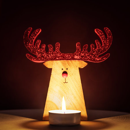 A Reindeer Christmas Decoration lit by a candleの写真素材