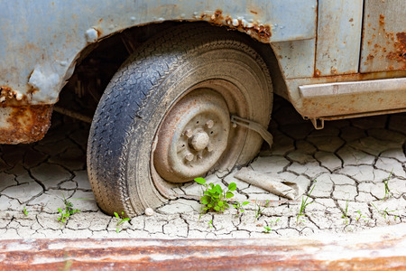 An image of an old car in the mudの写真素材