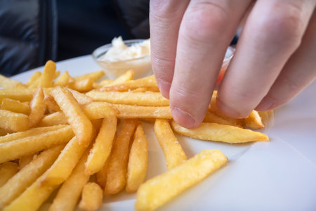 An image of grabbing some french friesの写真素材