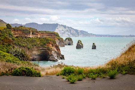 An image of sea shore rocks and mount Taranaki, New Zealandの写真素材