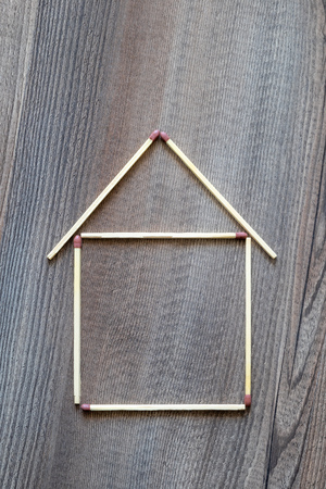 An image of a simple house of match sticksの写真素材