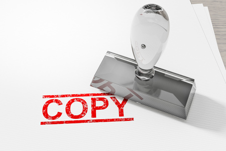 Red copy stamp on white paperの写真素材