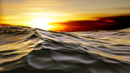 A golden sunset ocean wave background 3D illustrationの写真素材