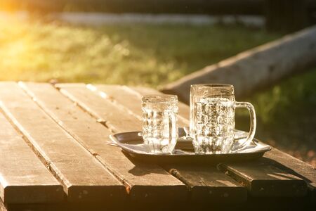 An image of glass jugs empty in the sunsetの写真素材