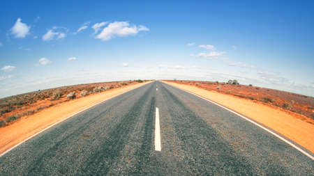 An image of a road in Australia with curved horizonの写真素材