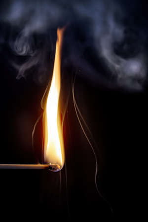 An image of a match flame dark backgroundの写真素材