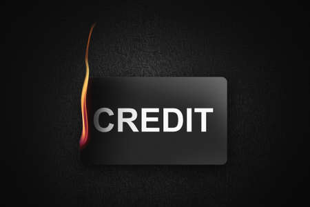 A burning credit card on black background illustrationの写真素材