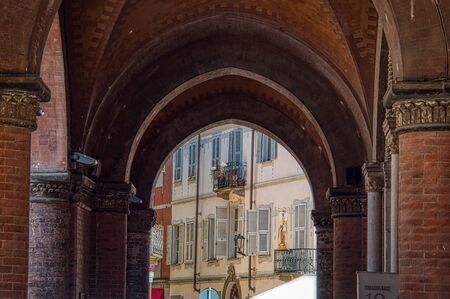 Beautiful look through an arch to some typical Italian housesの写真素材
