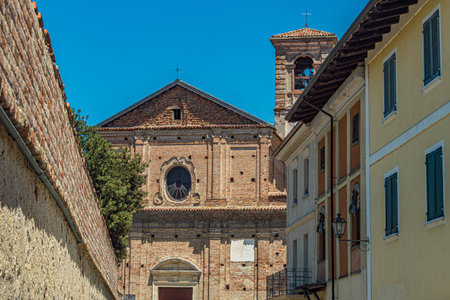Look to a typical Italian village with old houses and a church with the tower in the backgroundの写真素材