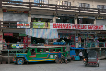 Banaue, Philippines - February 2012: Traveling in the Philippines - a bus is waiting in front of a...