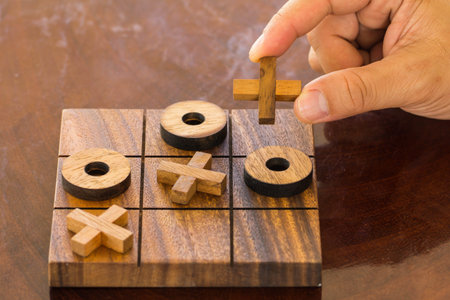 Hand playing Tic Tac To game