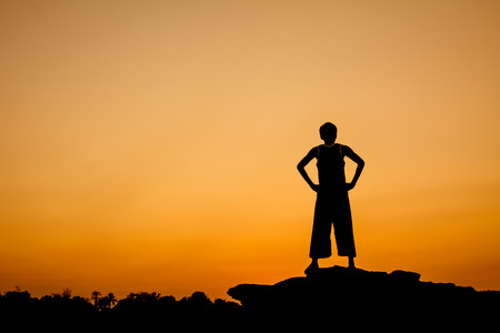Silhouette of a man in relaxing postingの写真素材