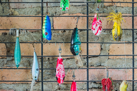 Fishing lure hanging on thw wallの写真素材