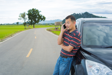 Asian man use smart phone during tripの写真素材