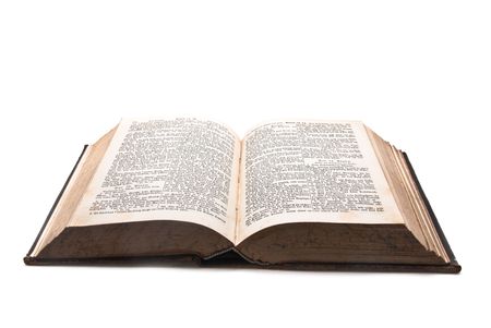 A very old bible lying opened on white background.の写真素材