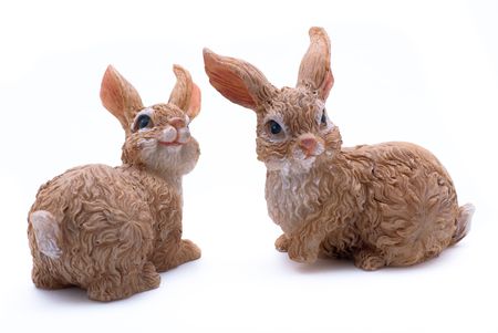 Two artificial easter rabbits sitting on white isolated background.の写真素材