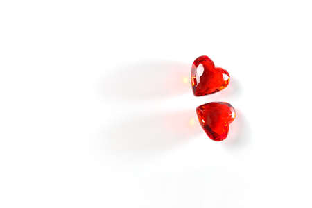 Directly Above Studio mage of Two Sparkling Red Gemstone Hearts, side-by-side, on a White Studio Background. This image has plenty of White Copy Space.の写真素材