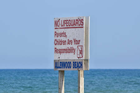 Swimming Safety Sign Posted Stating No Lifeguards Parents Children are Your Responsibilityの写真素材
