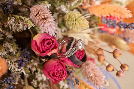 Diamond Wedding Ring with Wedding Band and Bouquet of Dried Wildflowersの写真素材