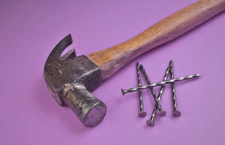 High Angle View of Hammer and Nails Isolated on a Lavender Purple Backgroundの写真素材