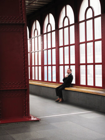 one passengers thinking and waiting at train station antwerpenの写真素材