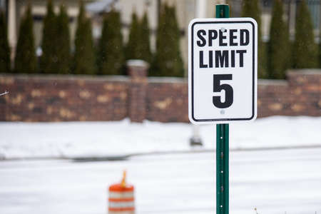 Speed Limit 5 Miles per Hour Sign with a Snow filled background.の写真素材