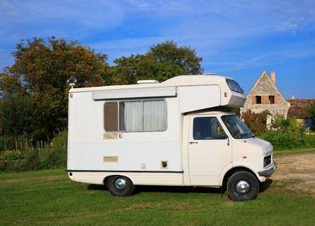 Old motorhome parked in a peaceful rural locationの写真素材