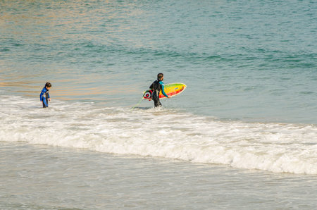 Father and son practice windsurfing on the beach of Cado Roig in Alicante, Spain one day of 2013