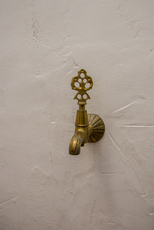 Nice golden and antique tap on white backgroundの写真素材