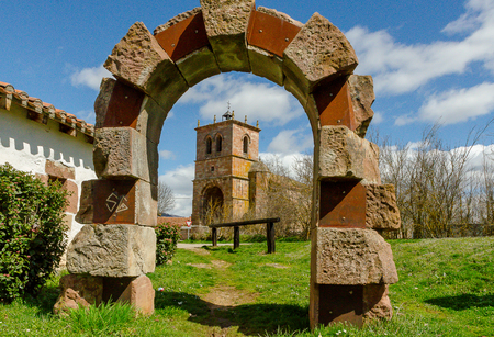 Stone arch with the church of Salinas  Pisuerga in the background.の写真素材