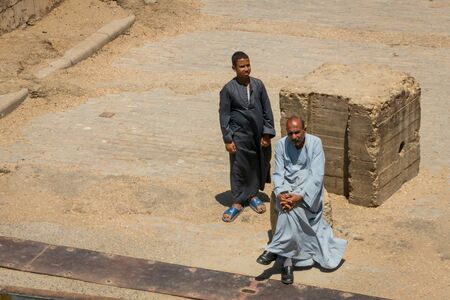 Man and boy watching the arrival of a cruise on the Nile. Egypt. April 2019のeditorial素材