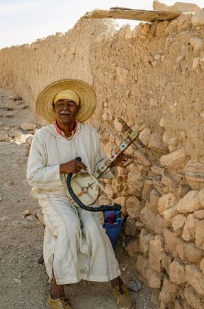 Man musician playing laud at the Kasbah Ait Ben Haddou in Ouarzazate, Morocco October 2019のeditorial素材