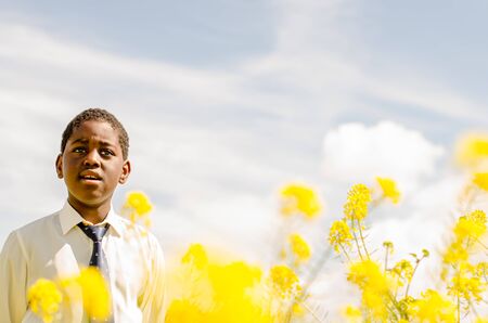 Black boy with white shirt and blue tieの写真素材