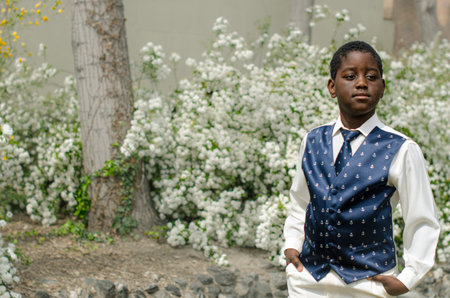 Black boy, white shirt, tie and blue vestの写真素材